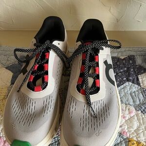 Stylish Gray and Black Sneakers with Red Accents